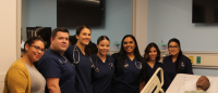 Columbia Nursing students stand next to advanced pediatric patient simulator Columbia Nursing students stand next to advanced pediatric patient simulator
